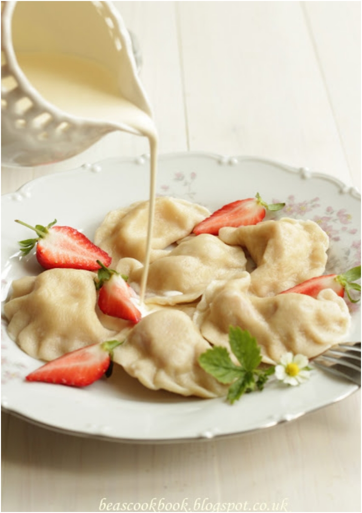 Polish PIEROGI - dumplings with strawberry filling and cream
